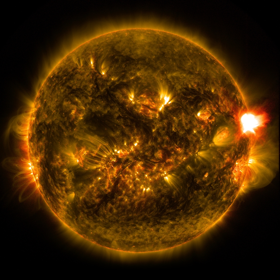 An M-class solar flare erupts from the right side of the sun in this image from shortly before midnight EST on Jan. 12, 2015. The image blends two wavelengths of light -- 171 and 304 angstroms -- as captured by NASA's Solar Dynamics Observatory. Image Credit: NASA/SDO