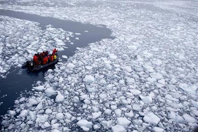 In this Jan. 22, 2015 photo, a zodiac carrying a team of international scientists heads to Chile's station Bernardo O'Higgins, Antarctica. Water is eating away at the Antarctic ice, melting it where it hits the oceans. As the ice sheets slowly thaw, water pours into the sea, 130 billion tons of ice (118 billion metric tons) per year for the past decade, according to NASA satellite calculations. (AP Photo/Natacha Pisarenko)
